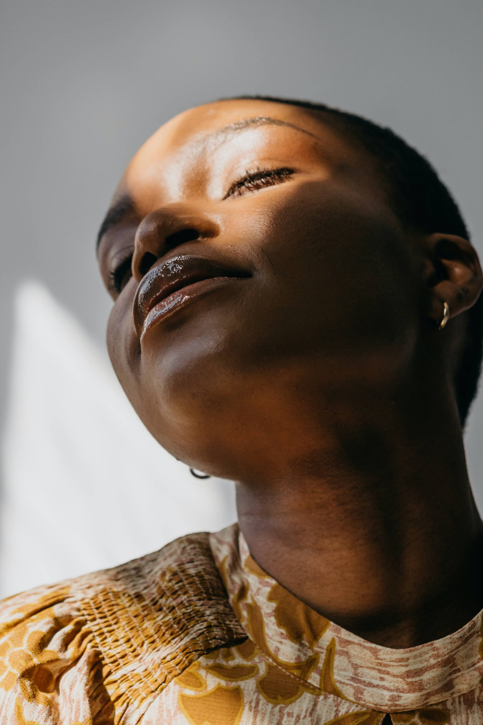 woman with glowing skin looking into light