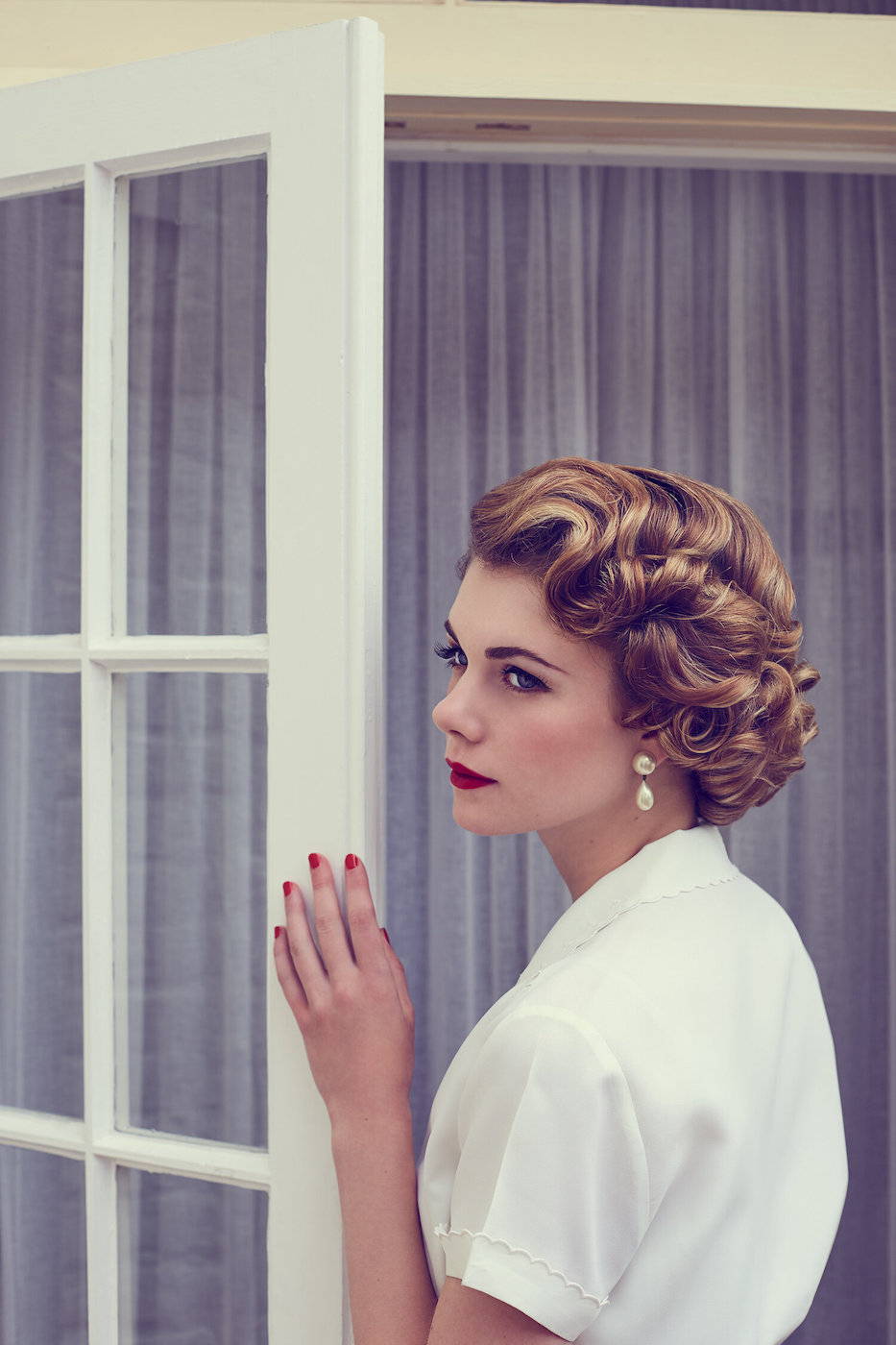 Model wears authentic 1950s style hair and make-up