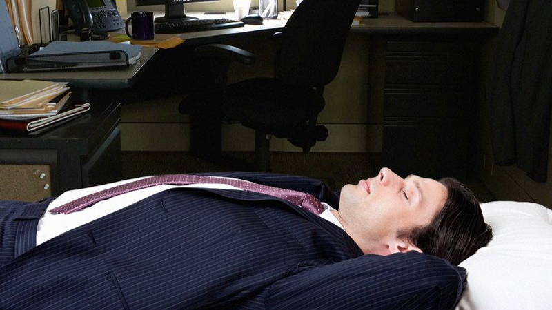 Image may contain: Person, Sleeping, Chair, Furniture, Table, Adult, Desk, Computer Hardware, Electronics, and Hardware