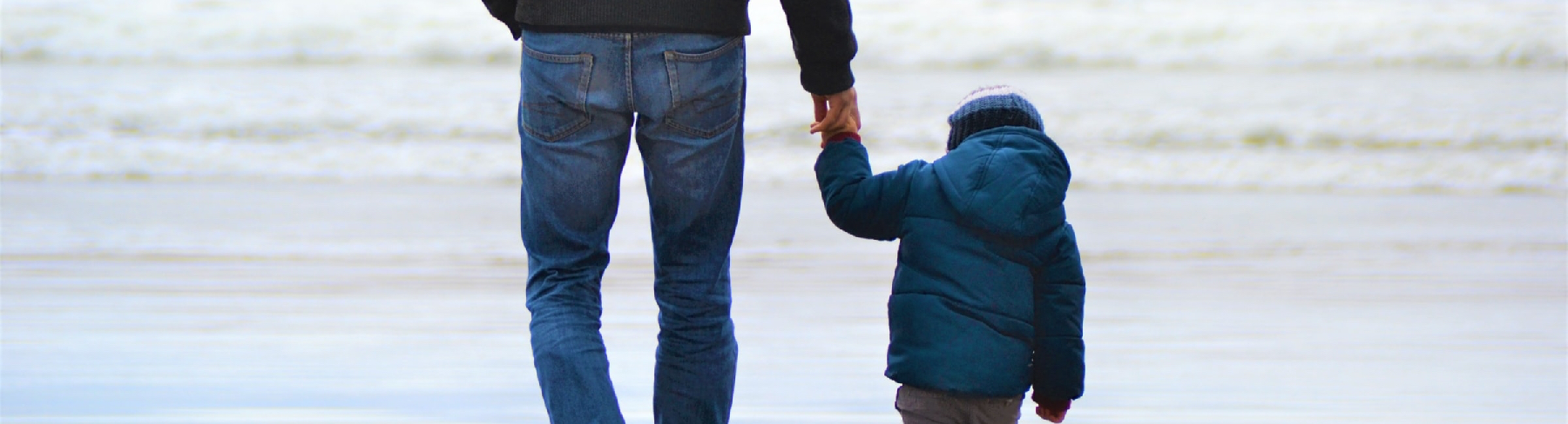 Man holding son's hand