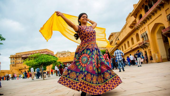 Woman dancing inside the courtyard of Amber Fort, Jaipur, Rajasthan, India