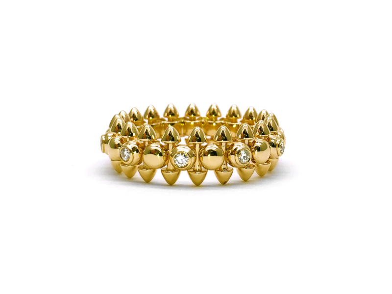 Solid yellow gold structural ring with small diamonds all around and peaks emerging at the top and bottom of the ring body