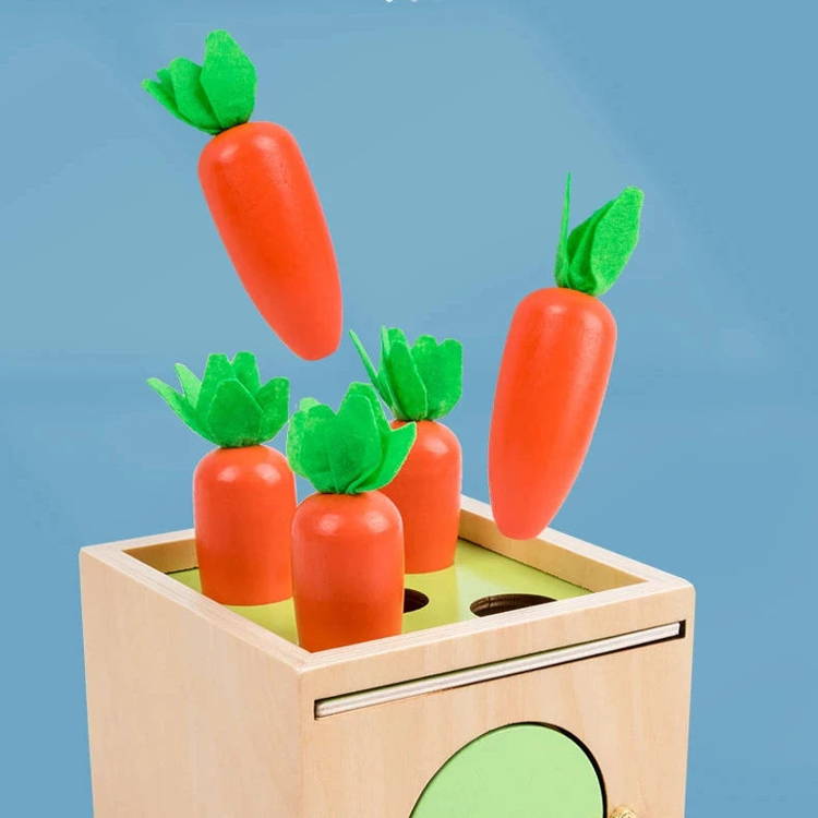 Carrot pieces from the Montessori 6-in-1 Sorting Tool toy falling into the wooden box.