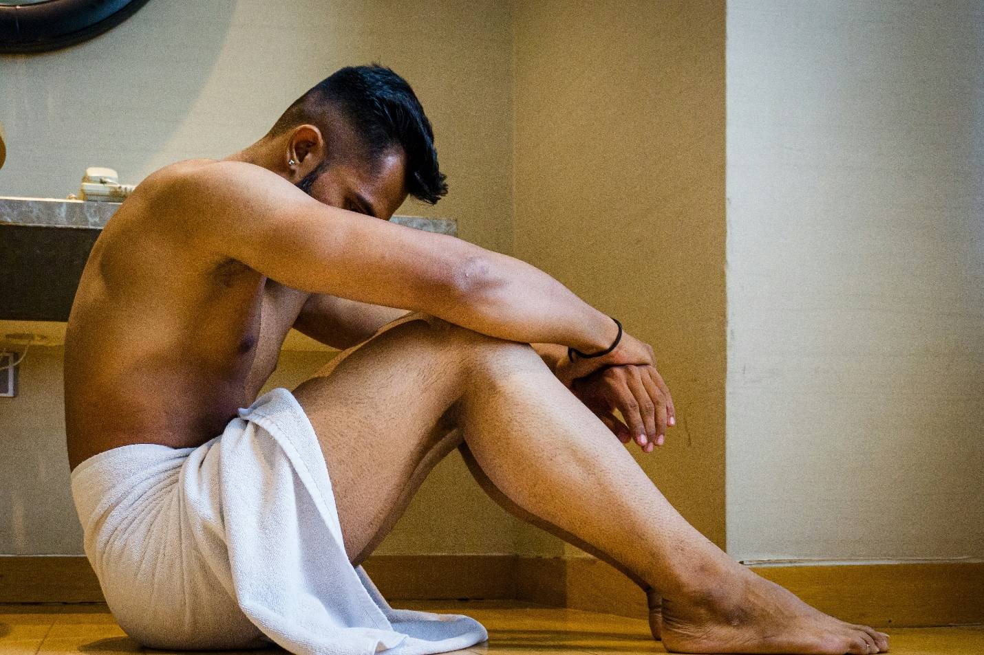 Man pinching his chest which is enlarged from gyno