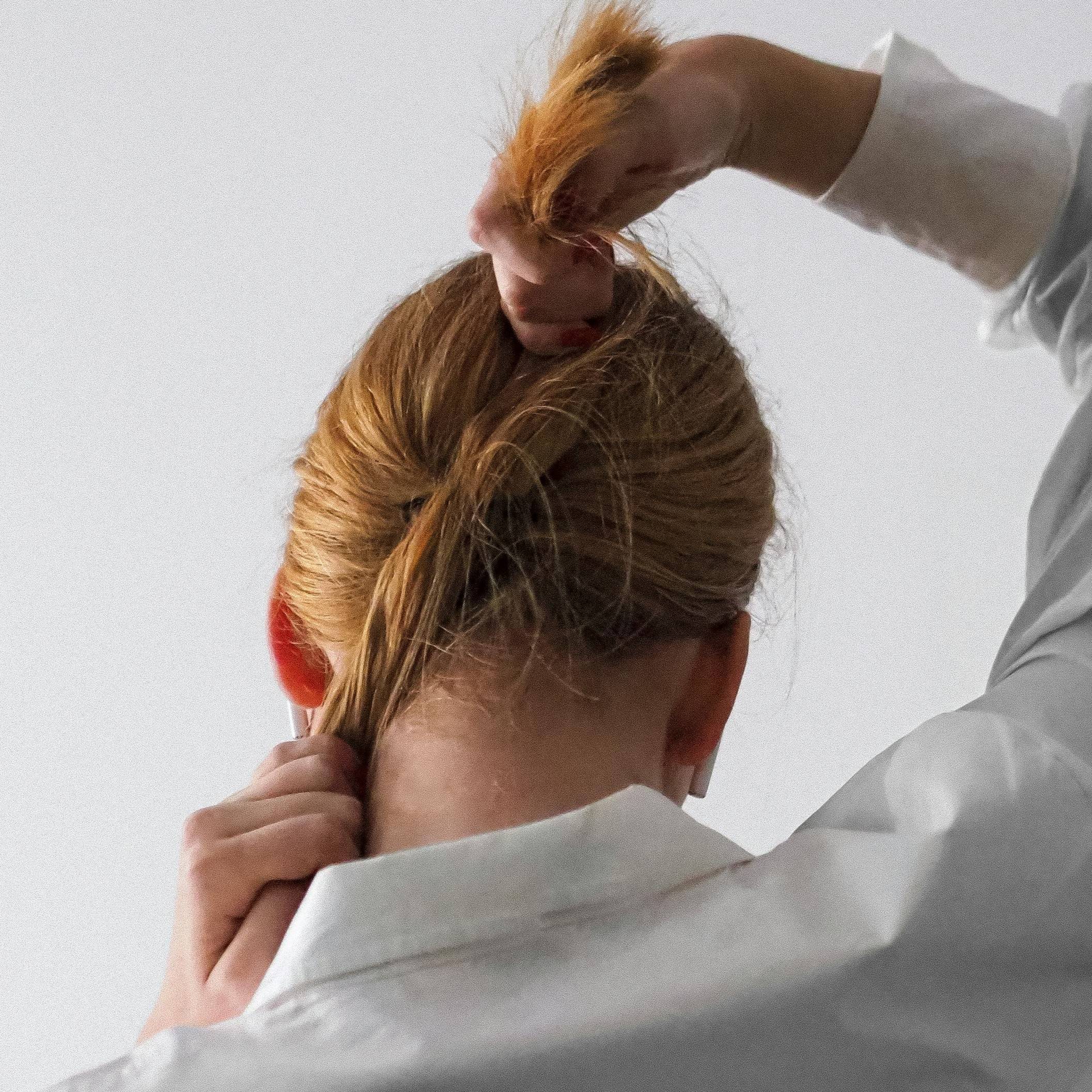 woman tying her ponytail