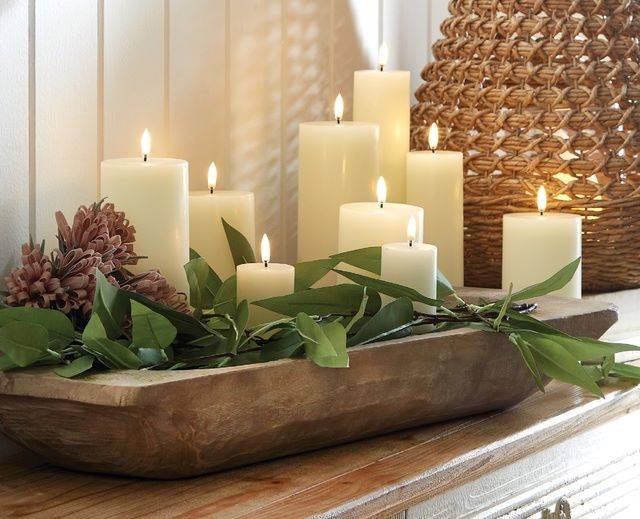 artificial pillar candles in a dough bowl with greenery