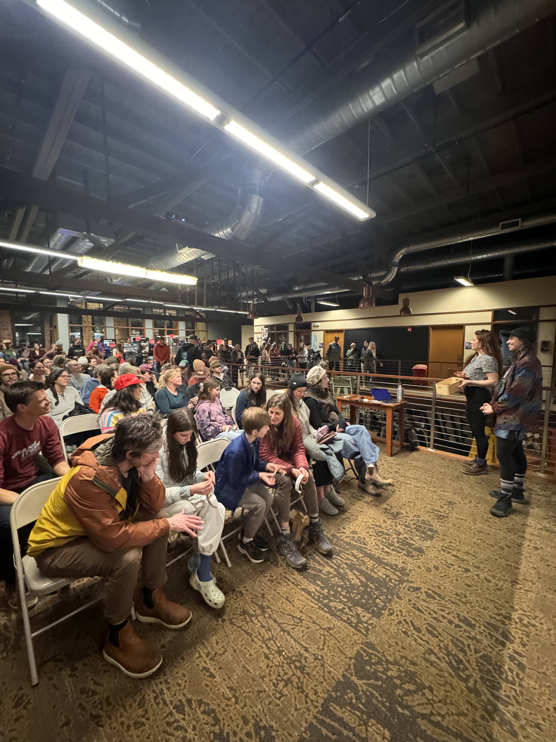 A large group gathers for an event at the shop.