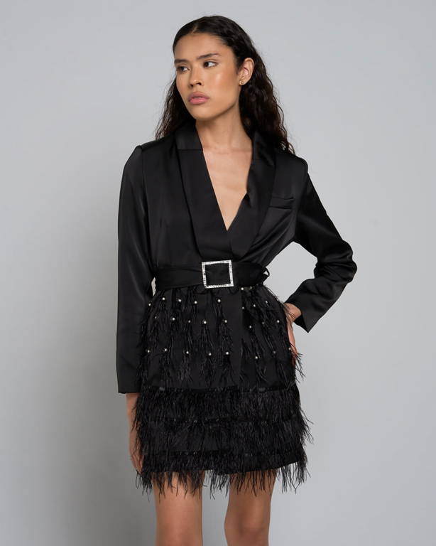 Model wearing a black belted blazer mini dress with feather trim