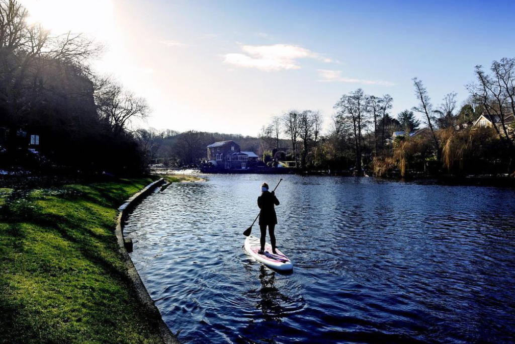 Inflatable paddle board in summer with hat