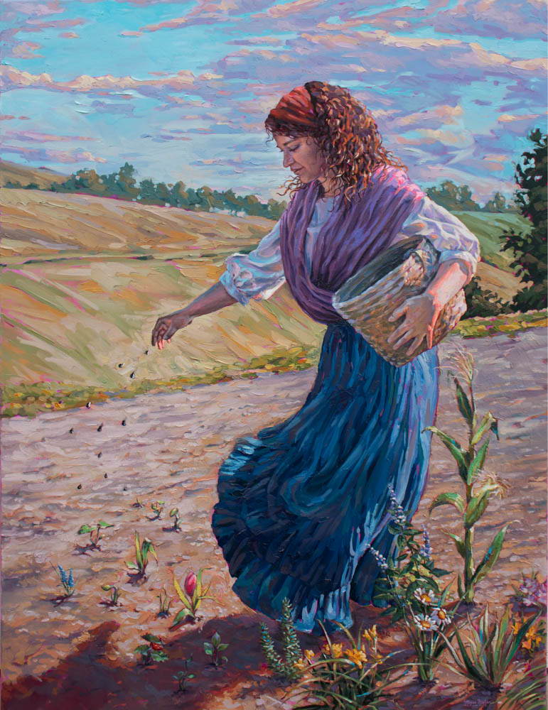 A woman is planting seeds in a field. 