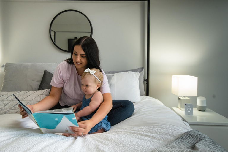 woman and daughter enjoying smart air conditioning control and google home smart assistant