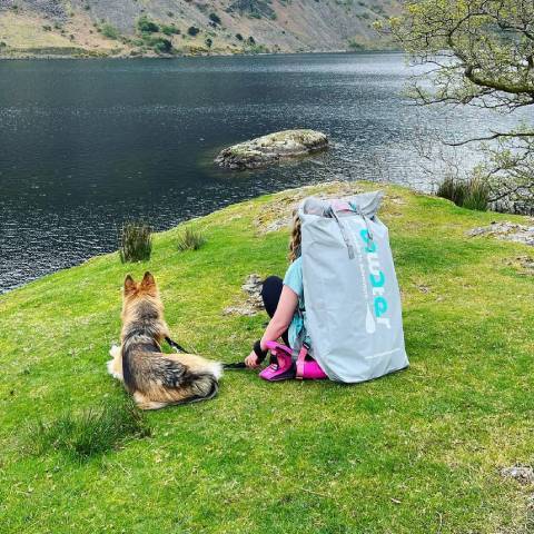 Girl wear Funwater backpack and sittig with her dog