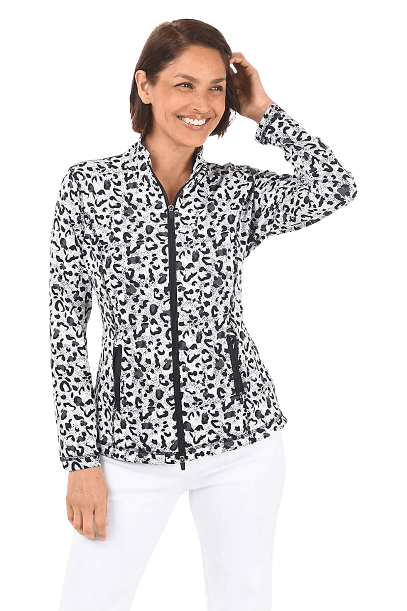 A woman wearing a black and white leopard spotted jacket and white pants