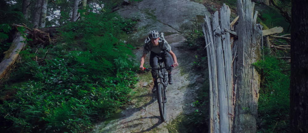 a man descending a mountain on an electric mountain bike