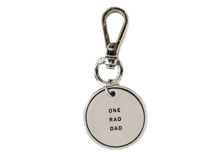 Circular keychain charm engraved with "One Rad Dad" in silver