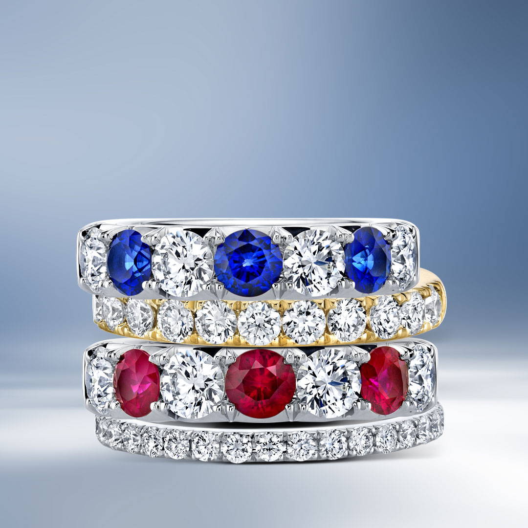 Four wedding bands with diamonds, rubies and sapphires