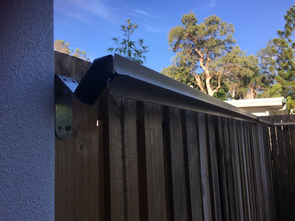 Wooden cat fence with Oscillot cat containment solution