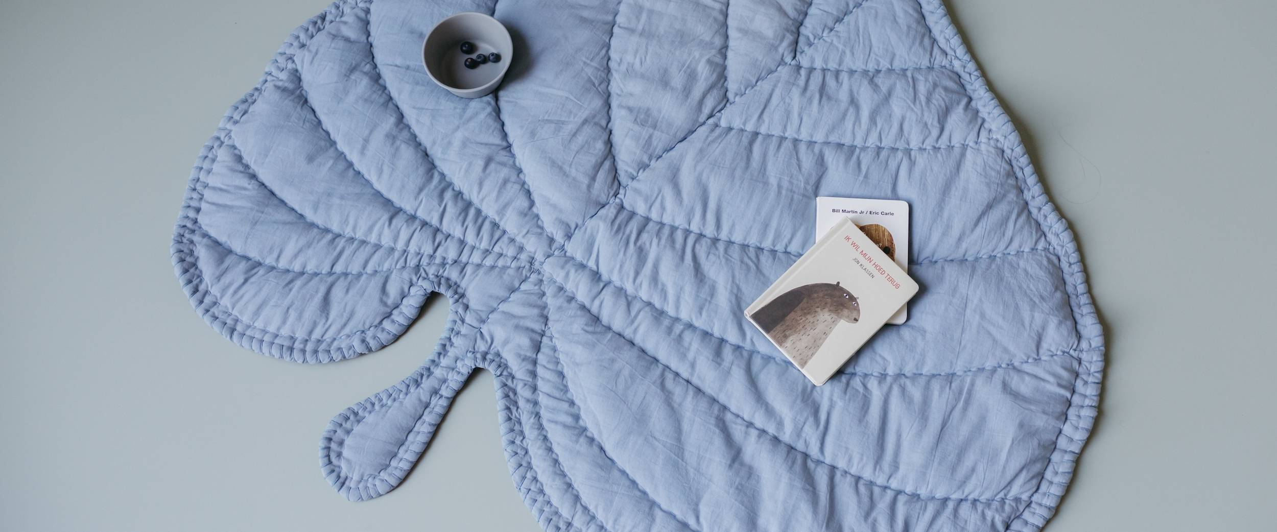 Nofred Blue Leaf Blanket on floor with toys