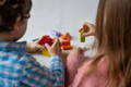 Children paying with colorful Montessori blocks.
