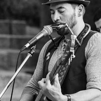 the singer, Carl playing harmonica and guitar