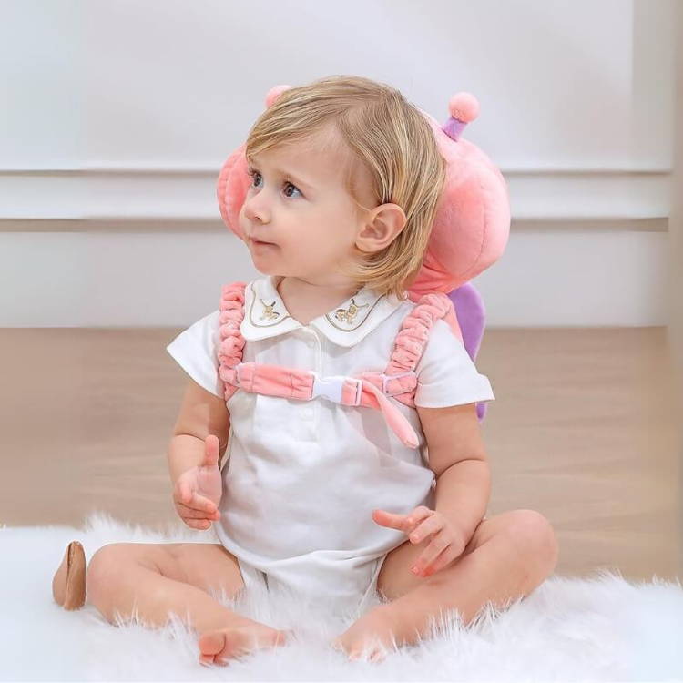 Baby girl wearing her protective backpack called Montessori Baby Guardian.