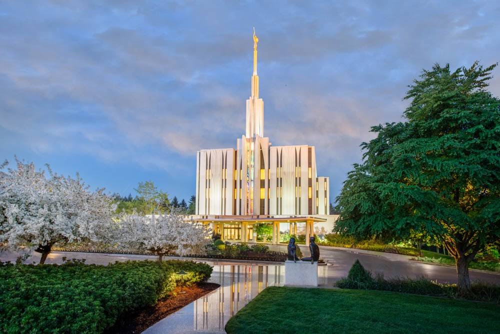 Seattle Temple picture with the temple lights reflecting off the pavement. 