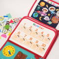 Close up on a number learning game featured on the Montessori Interactive Busy Bag, with other educational activities nearby.
