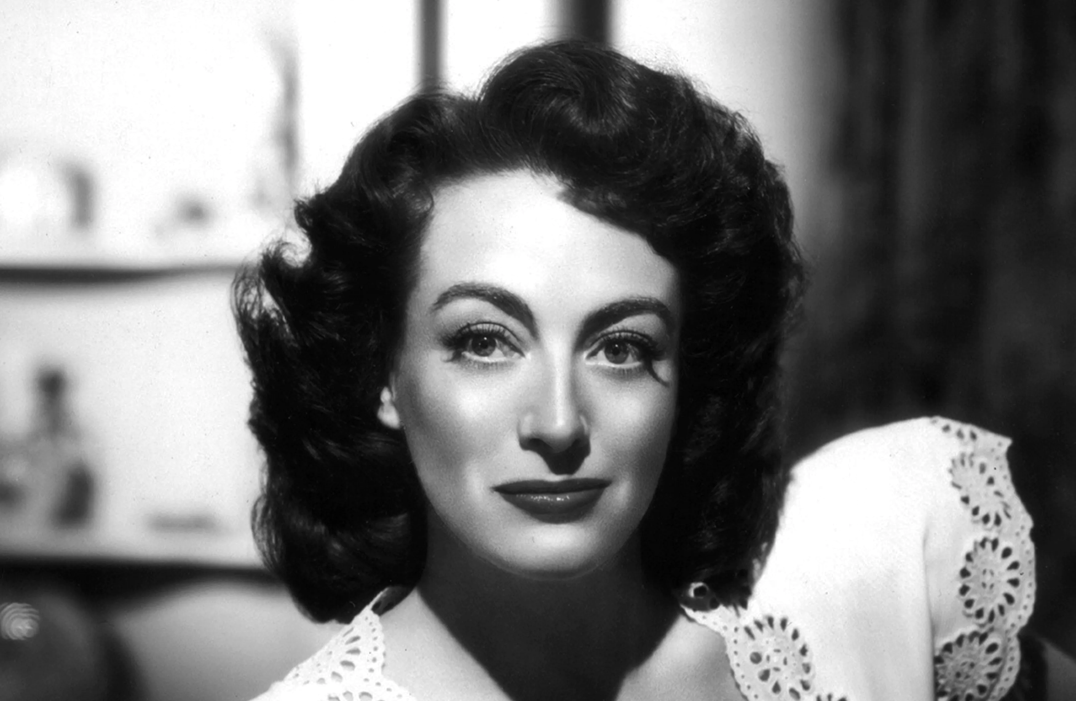 Black and white image of Joan. She is smiling calmly facing the camera.