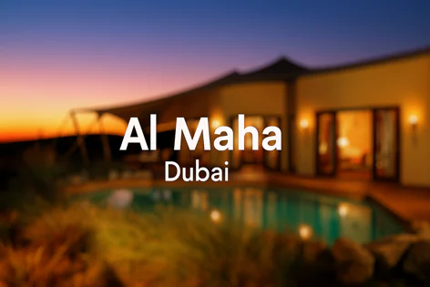 Al Maha Dubai luxury desert resort building and pool at sunset with beautiful twilight sky colors and warm lighting.