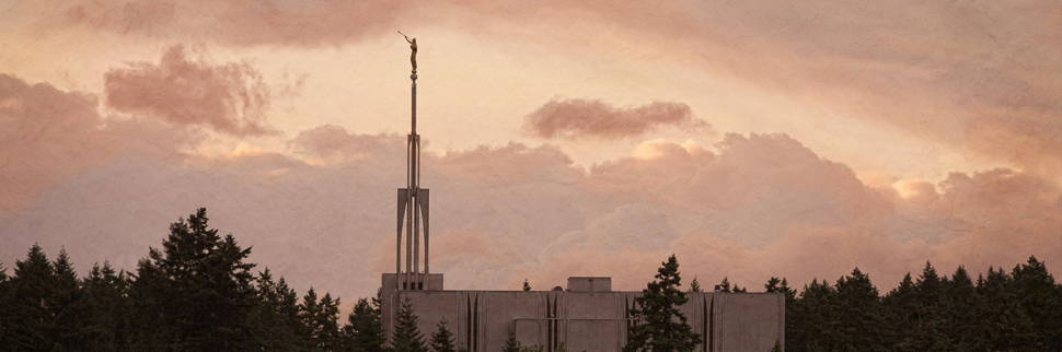 Panormic photo of the Seattle Temple standing above forest trees.