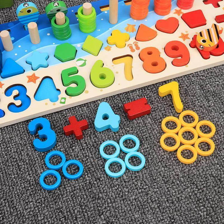 Close-up of a colorful wooden Montessori Smart Board children's toy with fish, rings, shapes, and numbers. 