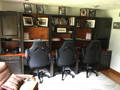 Custom wall unit with built in desks and cabinets on sides. Feature adjustable shelving.