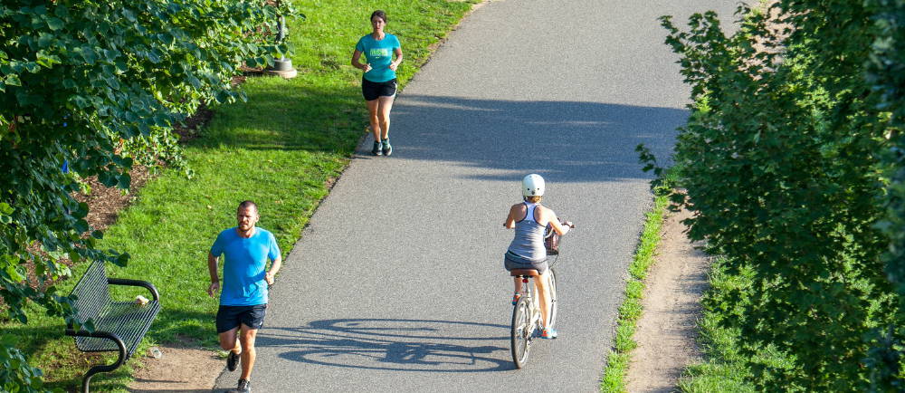 Runners and bicycle rider on multi-use recreational path