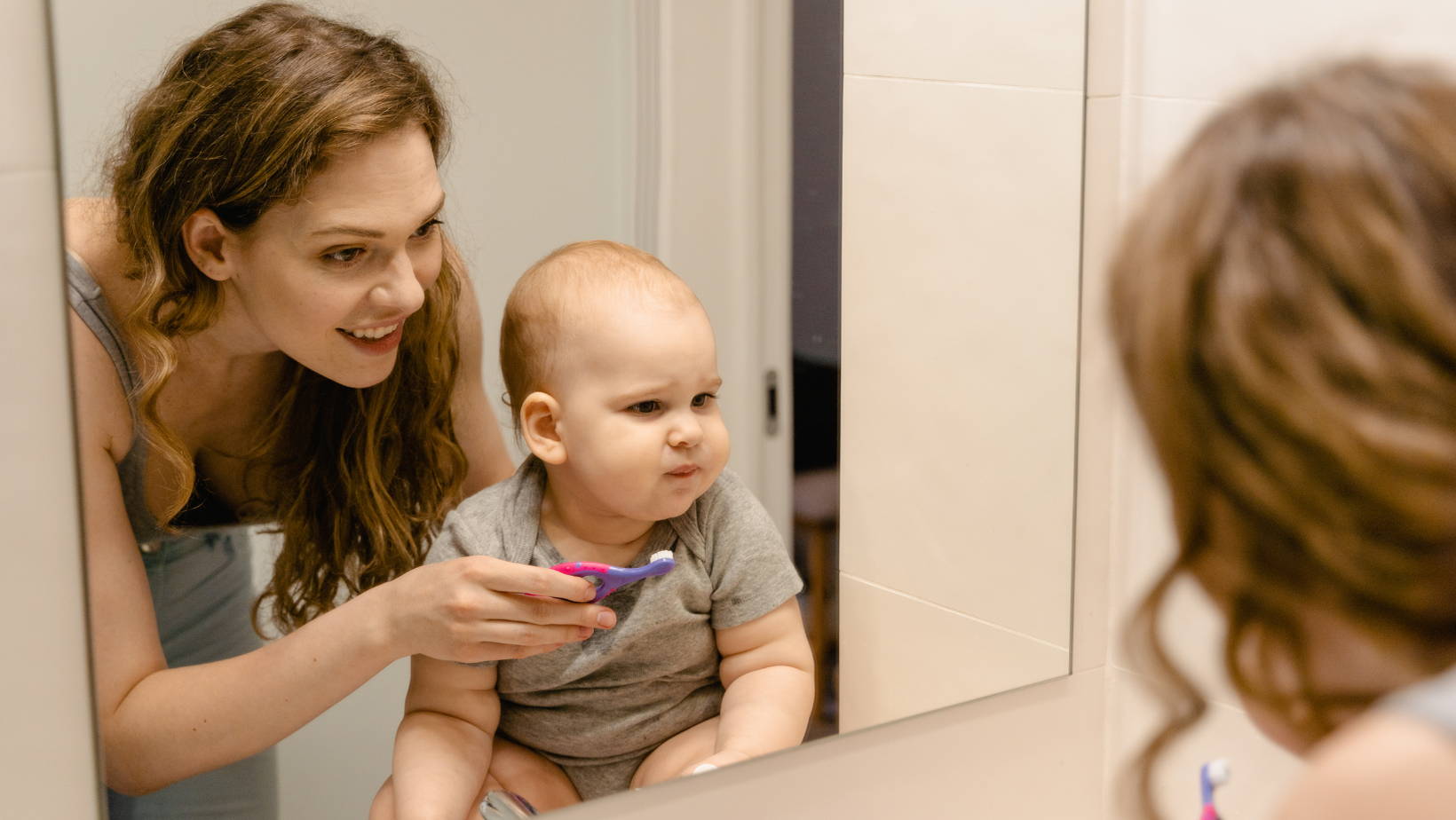 Mom brushing baby teeth | My Organic Company