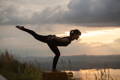 woman practicing yoga at sunset to calm her mind and reduce stress to help protect collagen 