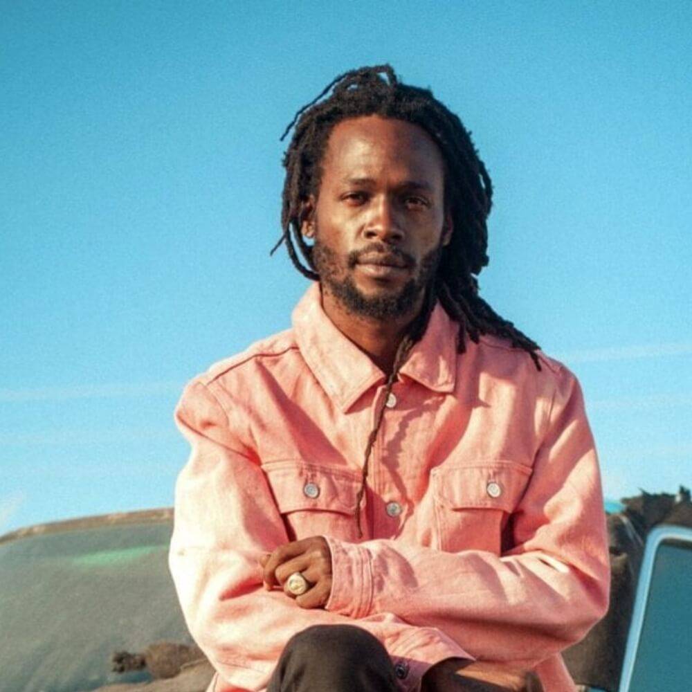 Jesse sitting on top of a car