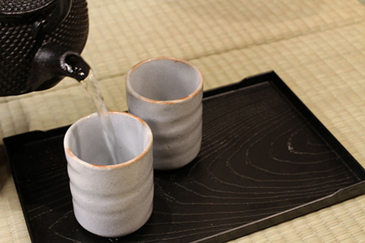 Pour hot water into yunomi tea cups to cool