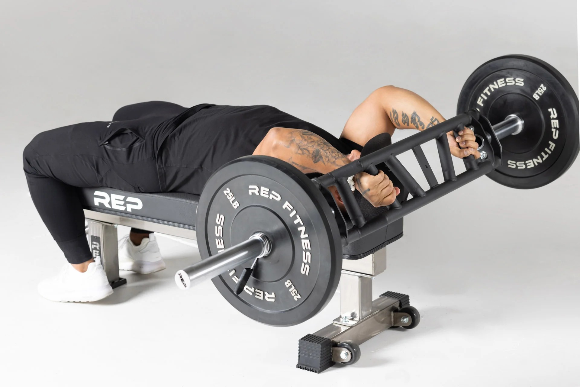 Man doing exercises with a Rep Cambered Swiss Bar
