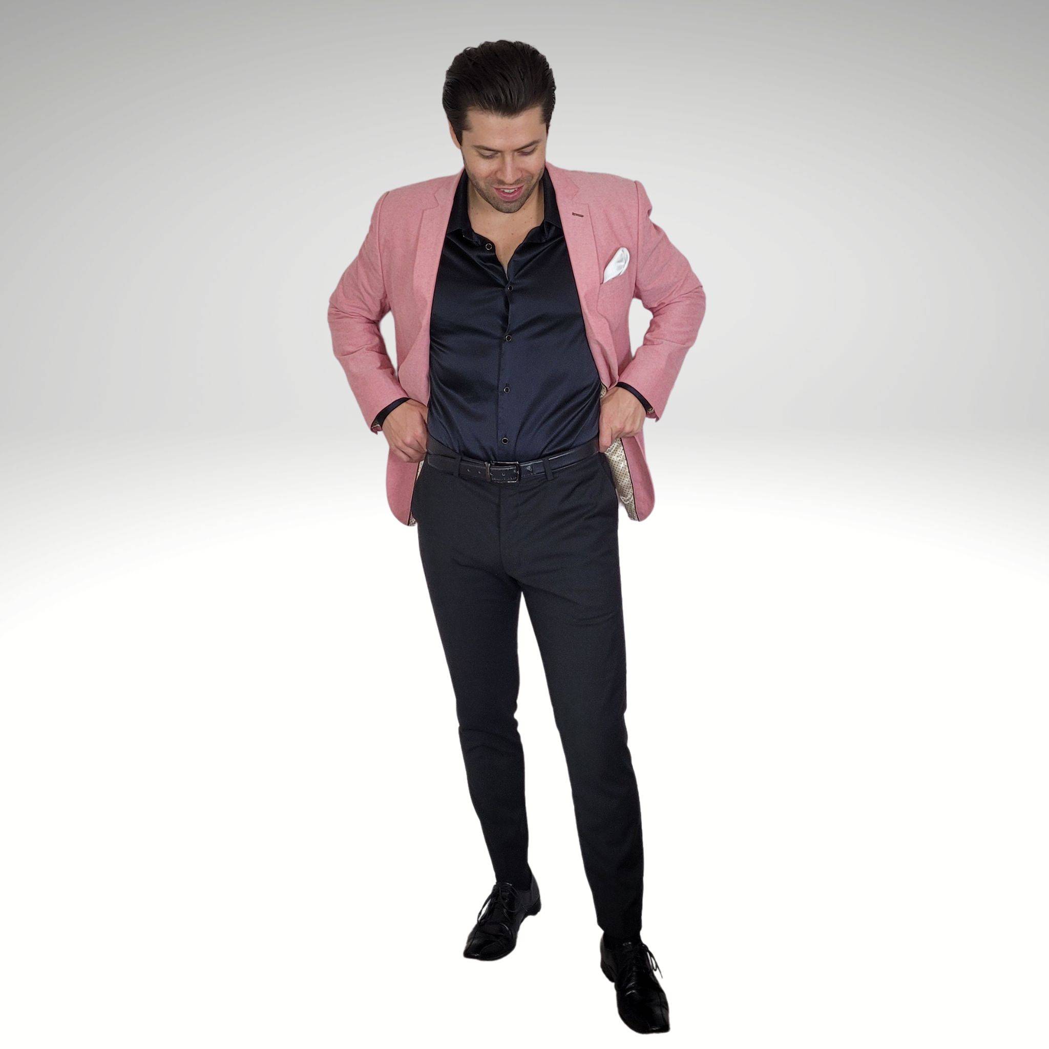 model wearing a light pink blazer black silk shirt black pants and black shoes