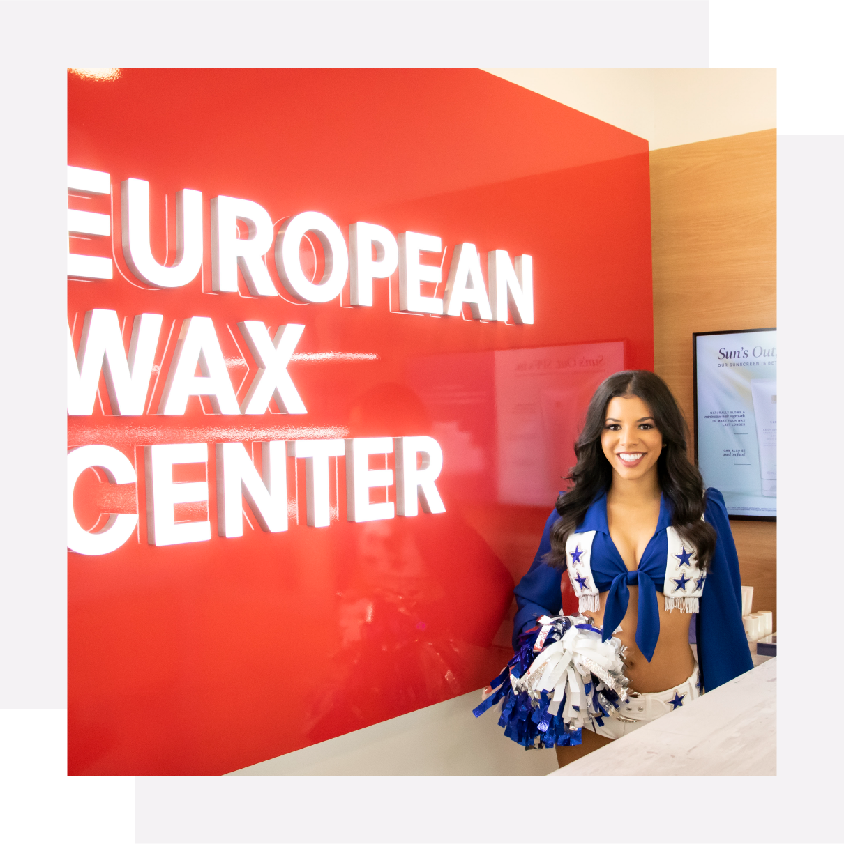 woman smiling next to European Wax Center log