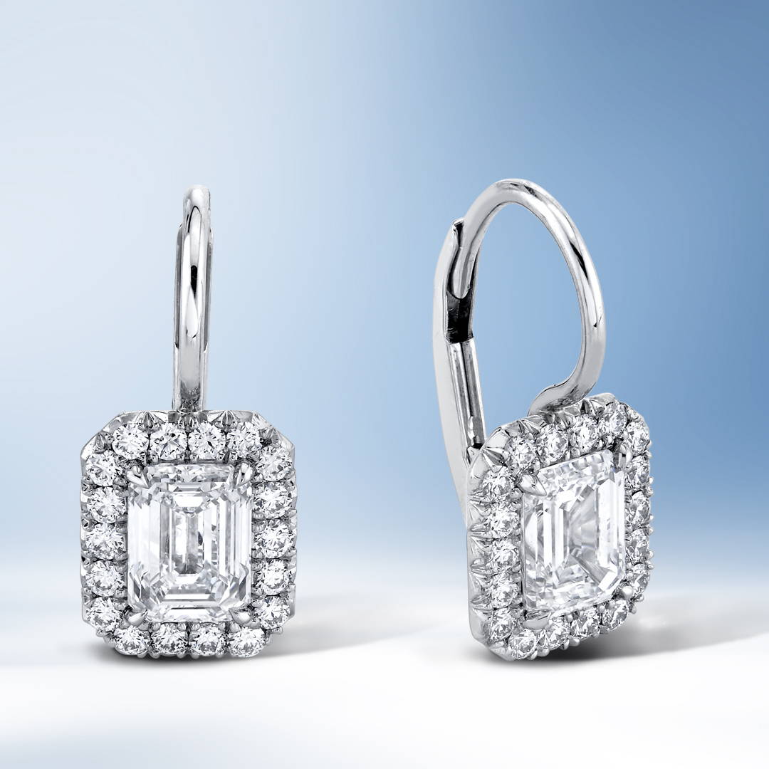 Emerald cut diamond dangle earrings in platinum