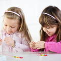 Girls doing crafts on a lawn