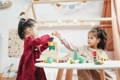 Children playing with wooden toys in a Montessori classroom.