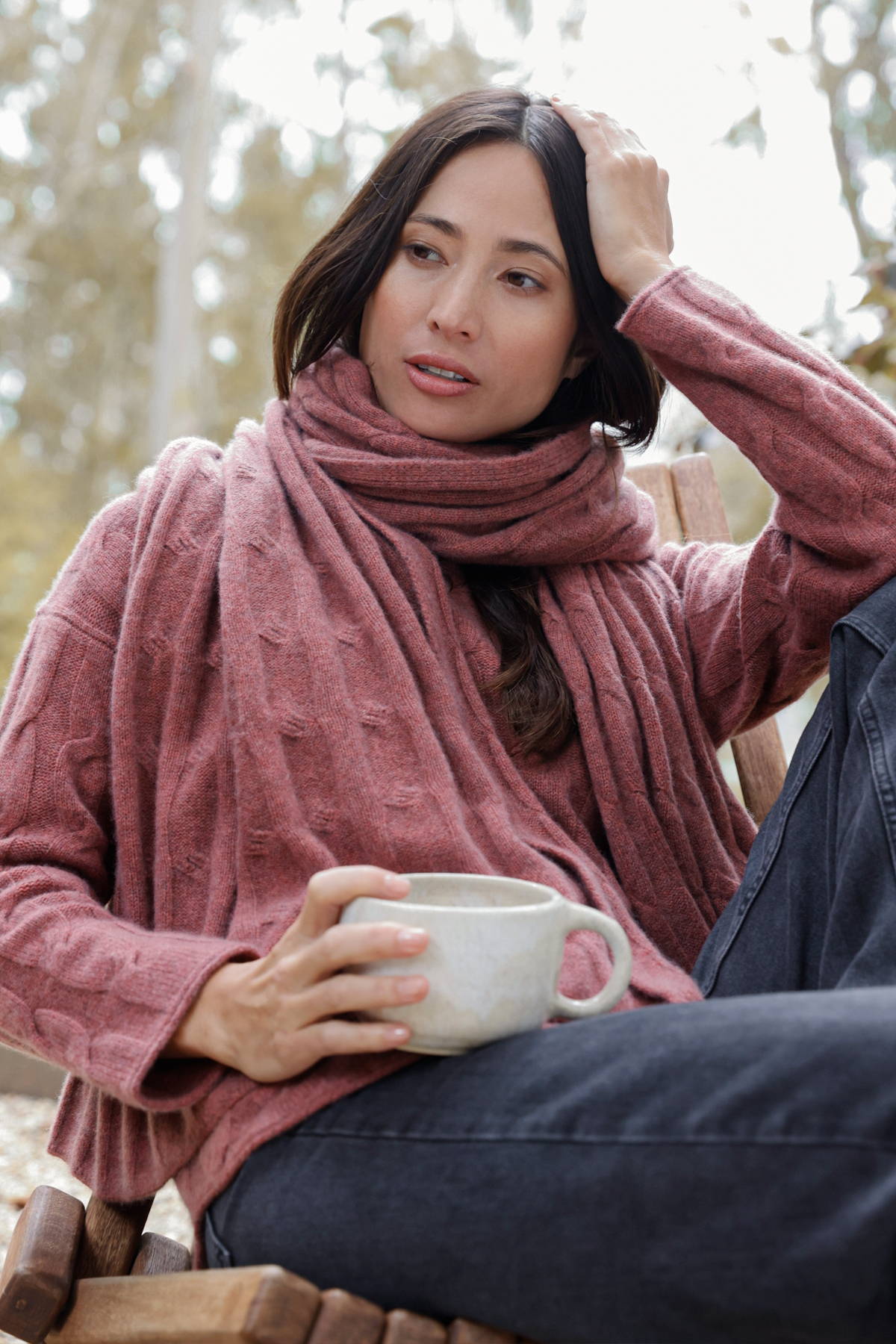 Woman wearing the red Shirttail Cable Pullover paired with the matching Luxe Cable Wrap