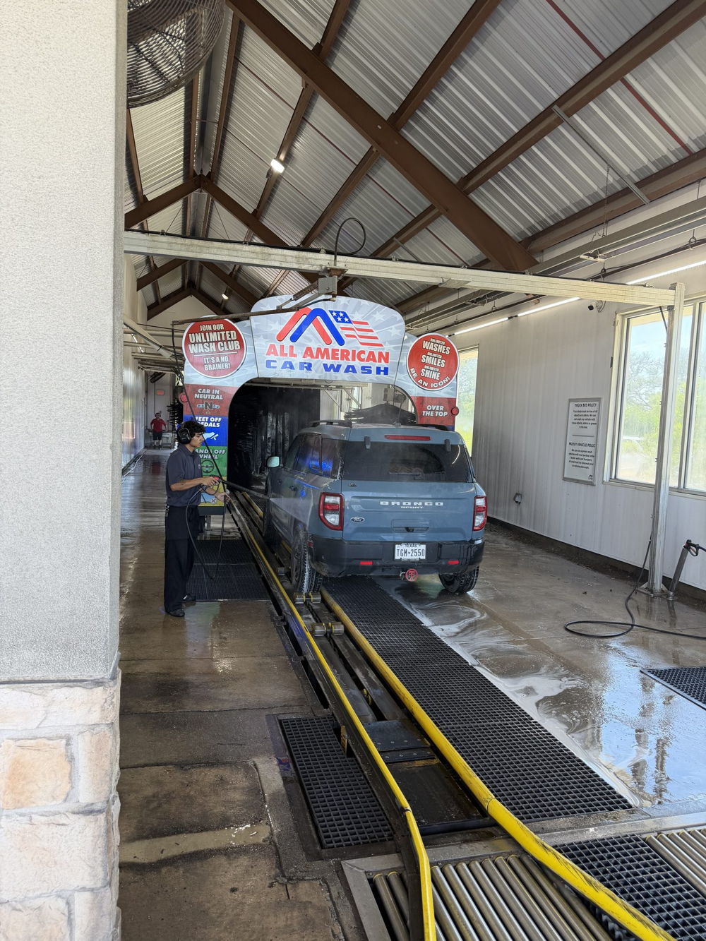 A vehicle entering the All American Car Wash express tunnel