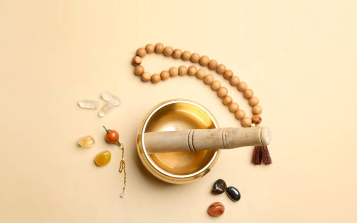A singing bowl and various beads and stones for Confetti's Sound Bath Class (Preview)