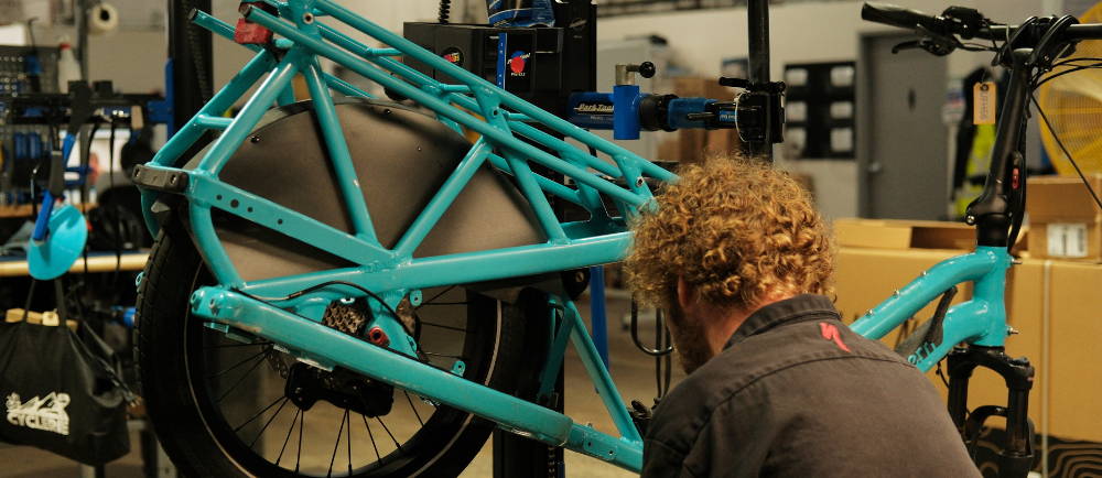 A mechanic working on an electric cargo bike