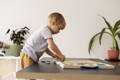 Kid playing with a Montessori Smart Board and learning how to count