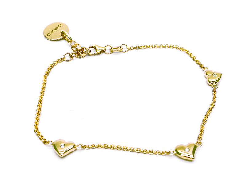 Yellow gold necklace with 3 hearts with small diamonds in the center spaced apart from each other