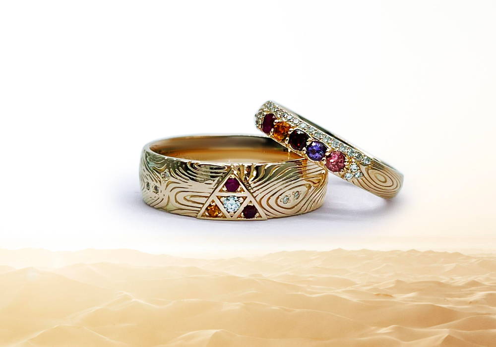 Duo of wedding rings for men and women in yellow gold with small diamonds and precious and semi-precious stones.